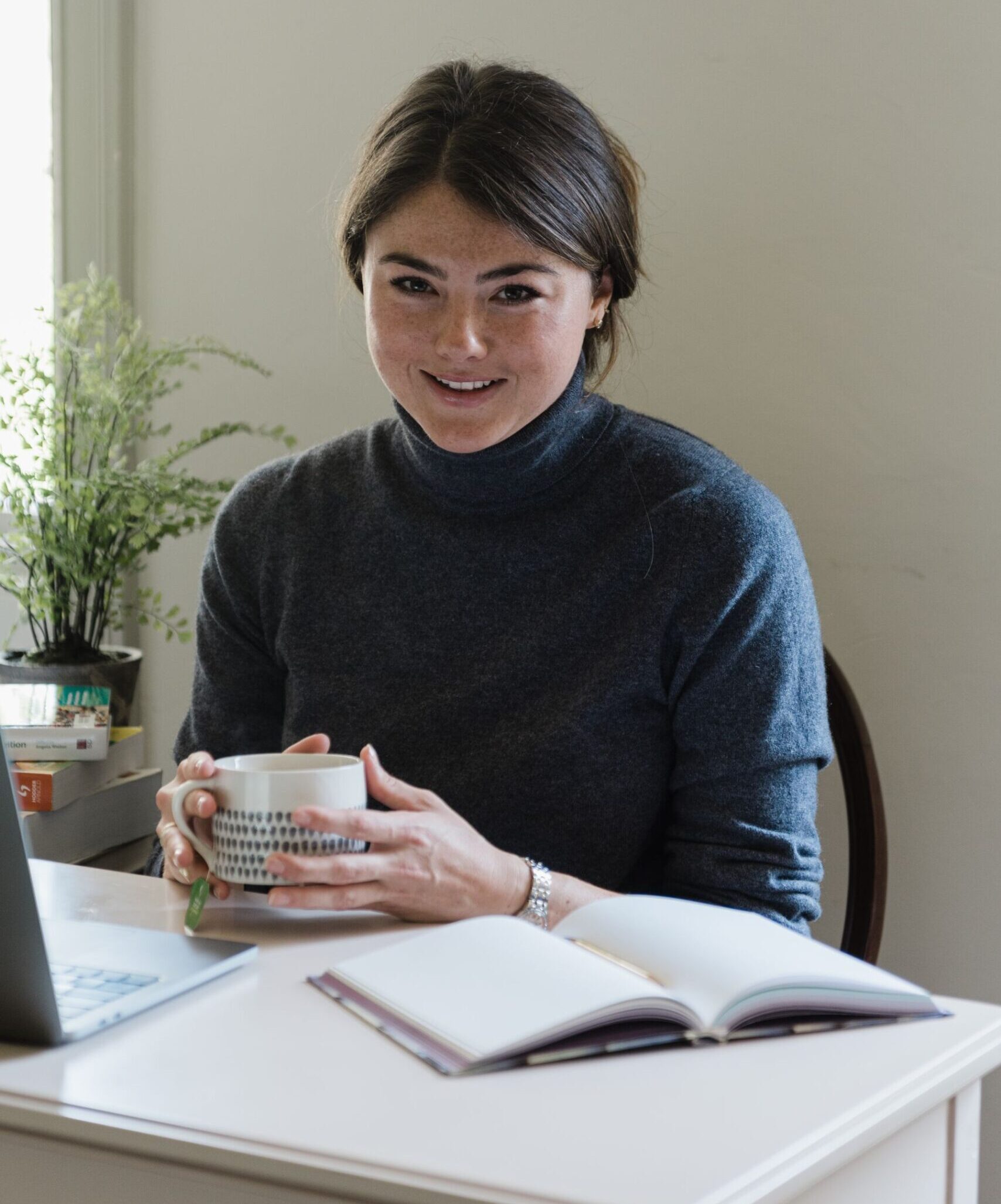 Georgina at desk with a mug