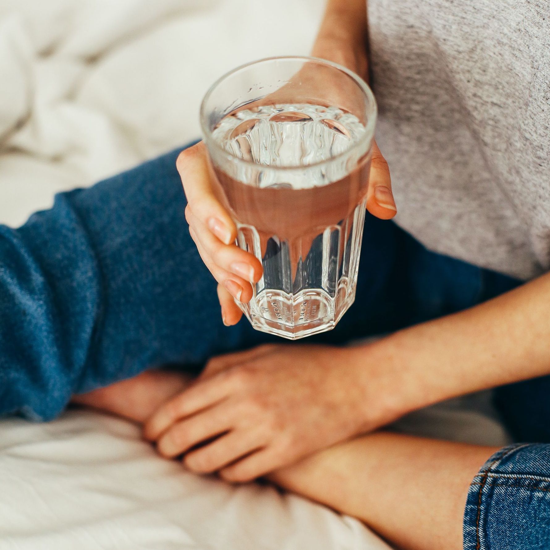 Woman holding glass of water